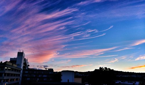 Low angle view of buildings against sky at sunset