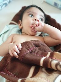 Cute baby boy lying on bed