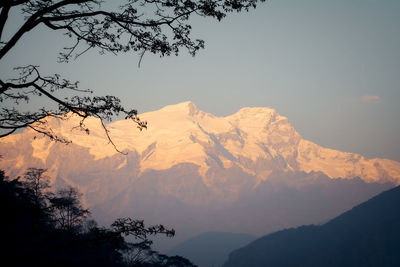 Scenic view of snowcapped mountains against sky during sunset