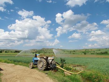 Tractor on field against sky