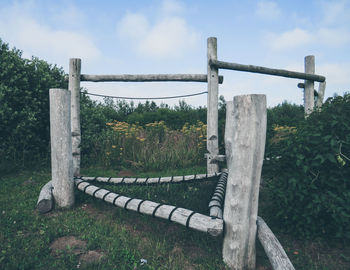 Metallic structure on field against sky