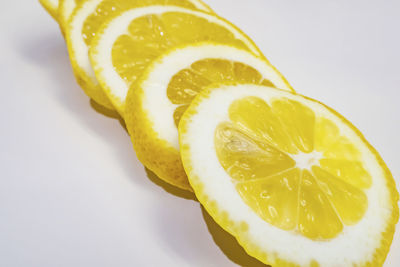 Close-up of lemon slice against white background