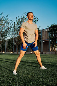 Full length of man exercising on field