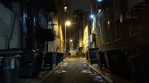 Street amidst buildings at night