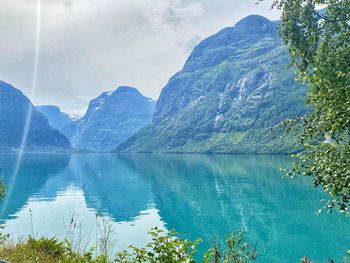 Scenic view of lake and mountains against sky