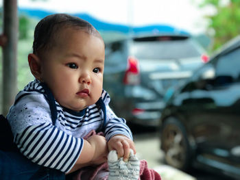 Portrait of cute baby girl in car