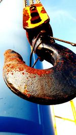 Close-up of rusty chain against sky