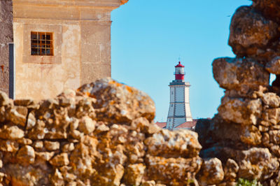 View of lighthouse against buildings