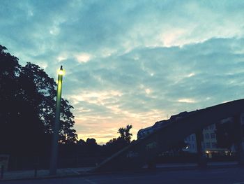 Buildings against cloudy sky at dusk