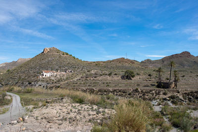 Scenic view of mountains against blue sky