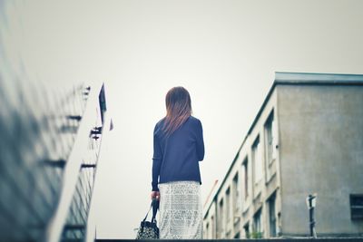 Woman standing against clear sky