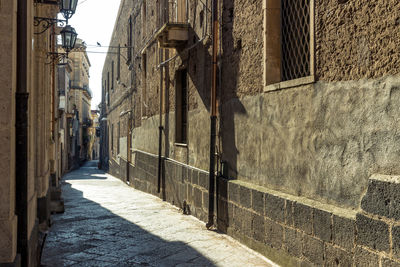 Narrow alley amidst buildings in city