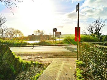 Empty road passing through field