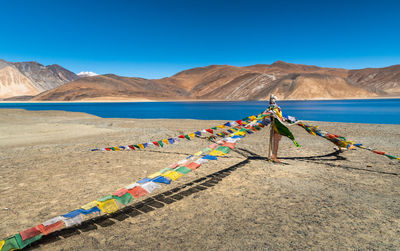 Himalayan prayer flags at pangong tso against mountain , leh , india