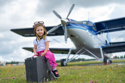 Portrait of girl standing on airplane