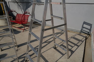 High angle view of empty chairs and table against building