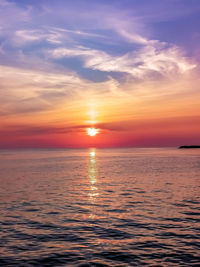 Scenic view of sea against romantic sky at sunset