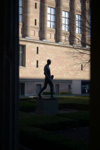 Side view of a silhouette man against building