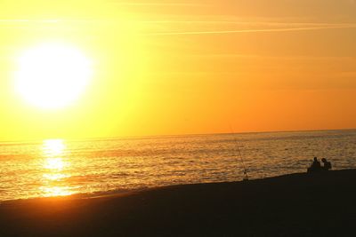 Scenic view of calm sea at sunset