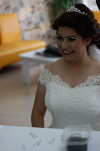 Smiling bride looking in mirror