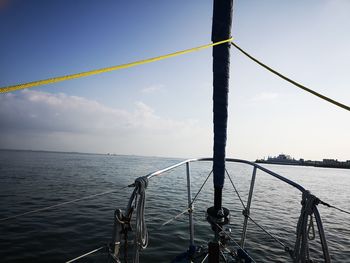 Railing by sea against sky