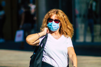 Portrait of woman standing in city