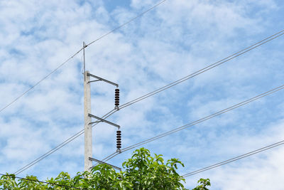 Low angle view of electricity pylon against sky