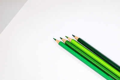 High angle view of colored pencils against white background