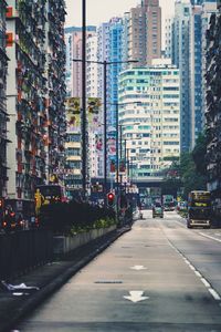 Road amidst buildings in city