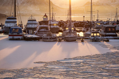 Boats moored at harbor during winter