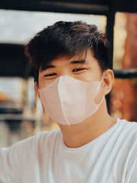 Portrait of young man wearing mask
