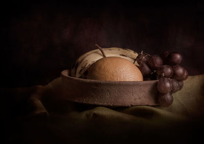 Close-up of fruits over colored background