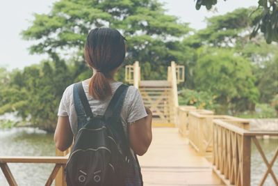 Woman standing on footbridge