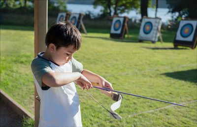 Boy holding bow and arrow