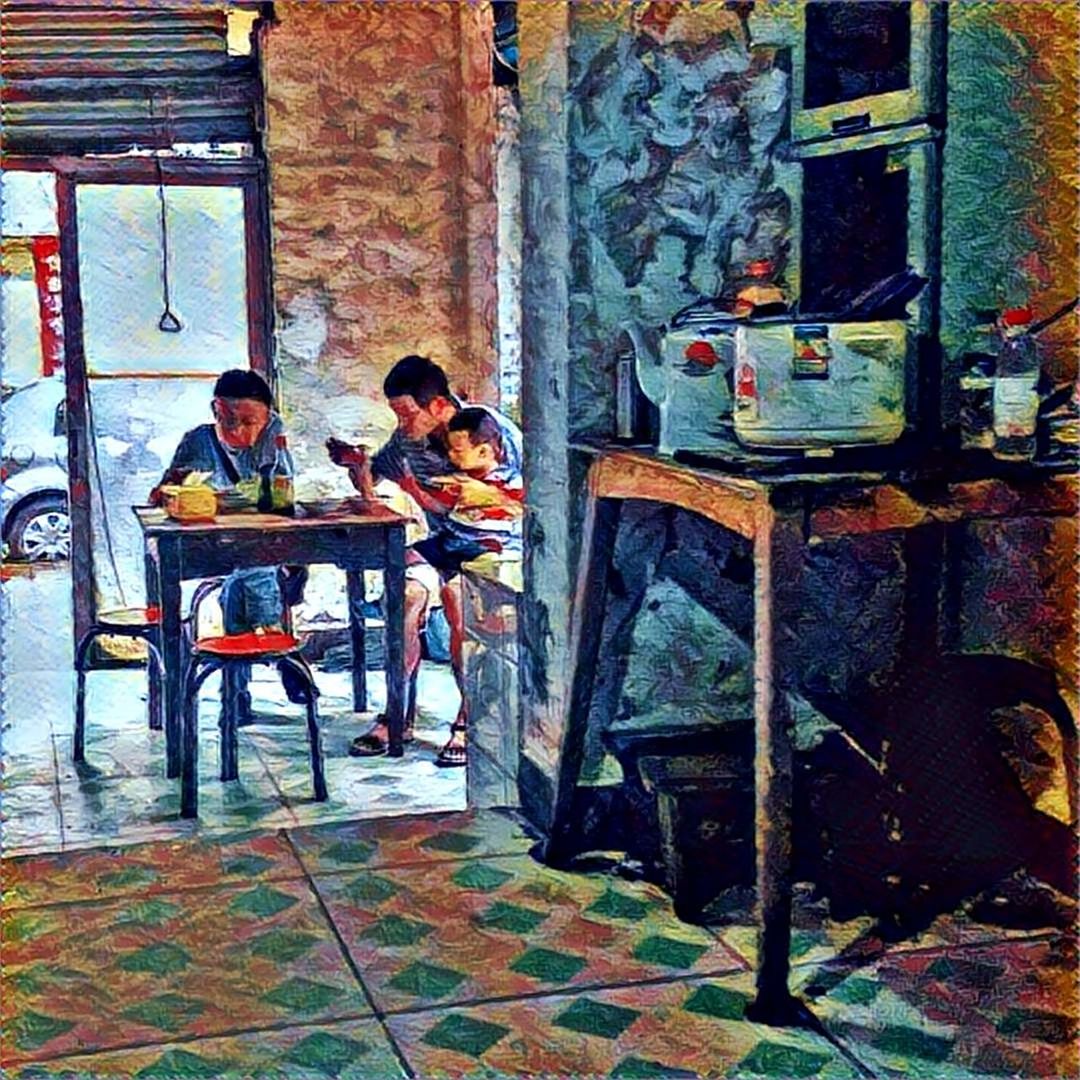 YOUNG MAN SITTING ON TABLE