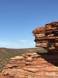 Rock formations against clear blue sky