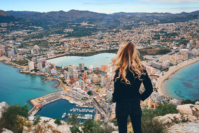 Rear view of woman looking at city buildings