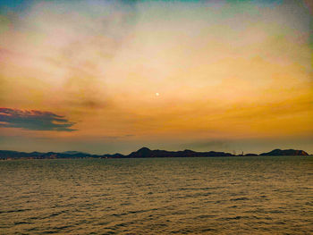 Scenic view of sea against romantic sky at sunset