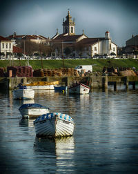 Boats at port against buildings