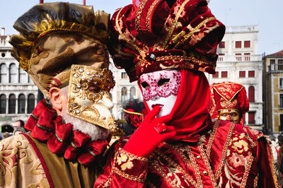 Full frame shot of traditional mask against building in city