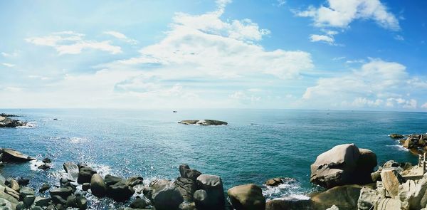 Scenic view of sea against cloudy sky