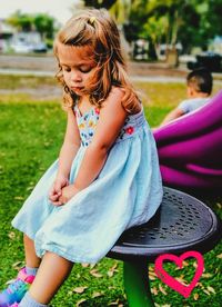 Girl sitting on field