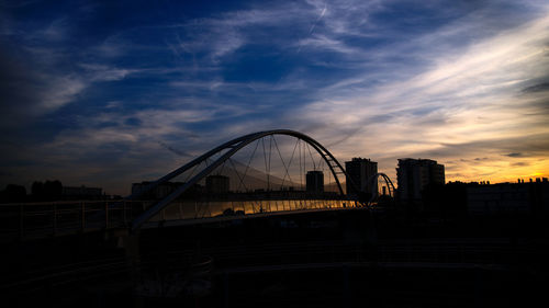 View of suspension bridge against cloudy sky