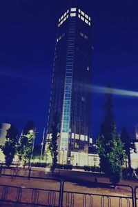 Low angle view of illuminated building against blue sky