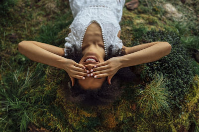 Low section of woman sitting on grass