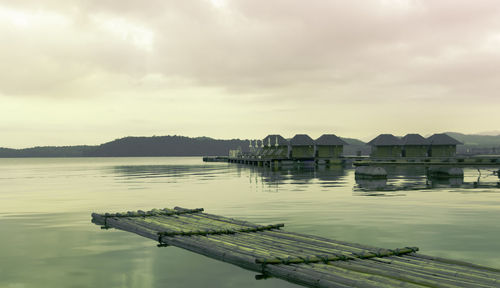 Pier over lake against sky