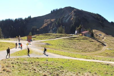 People walking near hillside