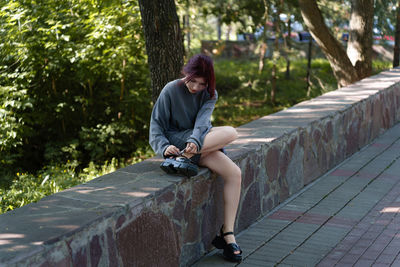 Portrait of young woman sitting on steps