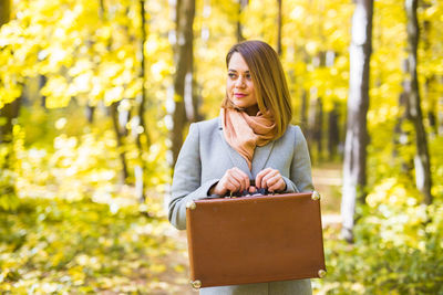 Portrait of a smiling young woman in autumn