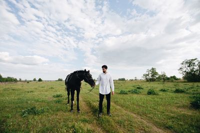 Man with horse on field